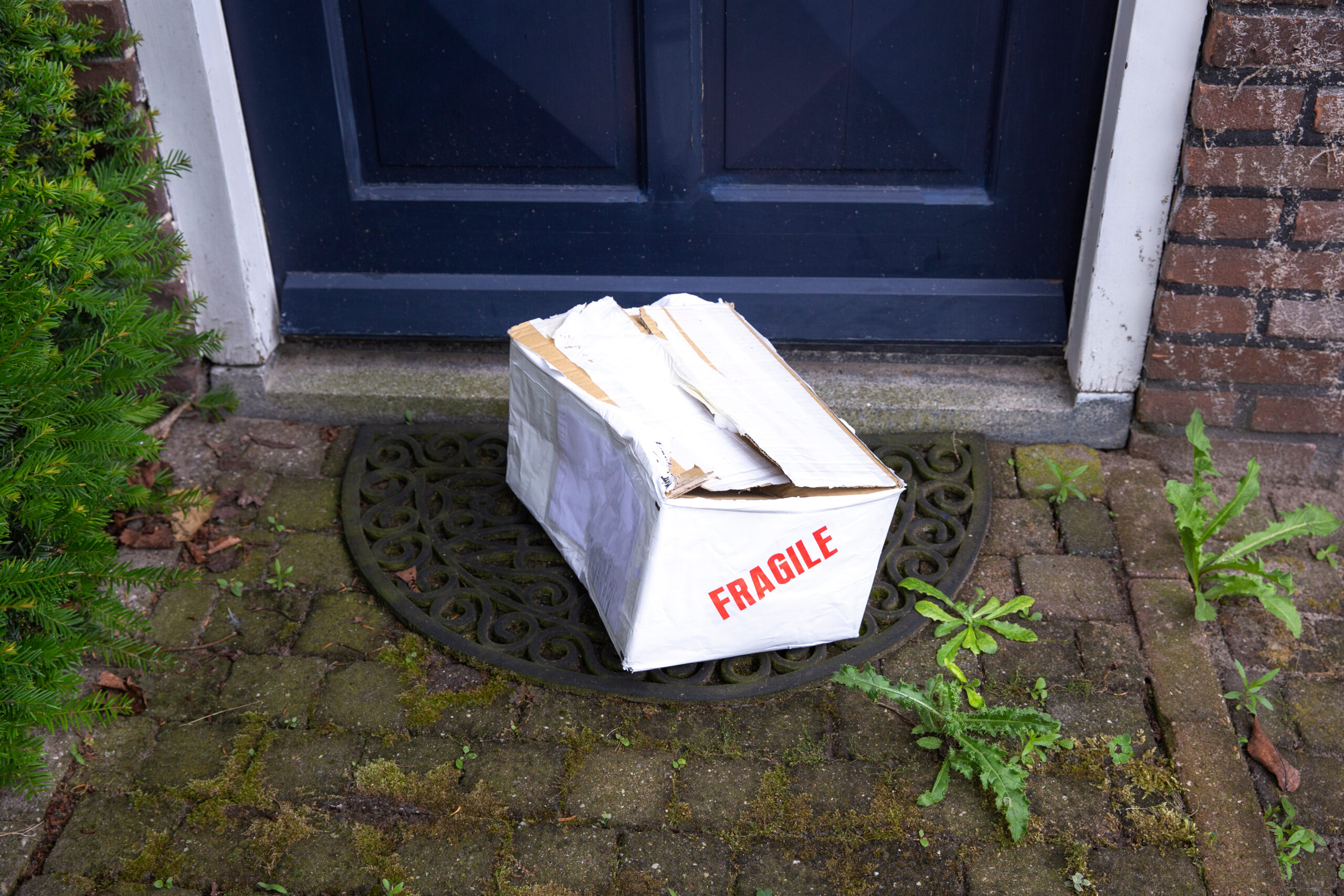 Damaged,Delivery,Cardboard,Box,At,Front,Door,Of,A,House,